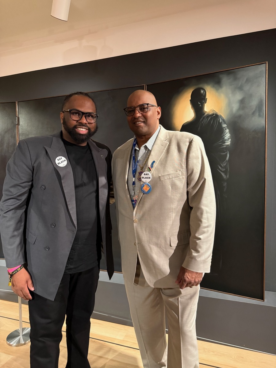 Cedric at art gallery event with colleague