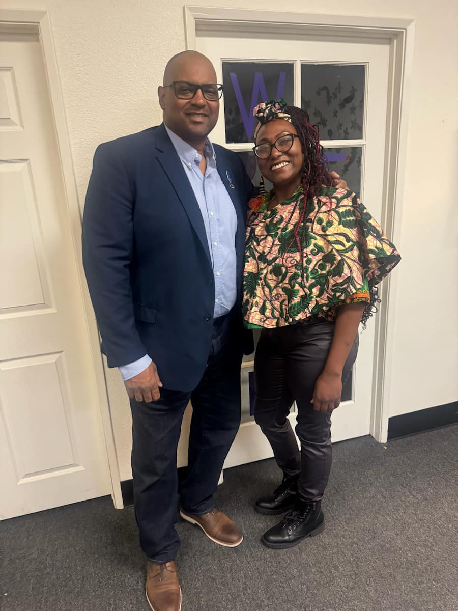 Cedric with community member at local event