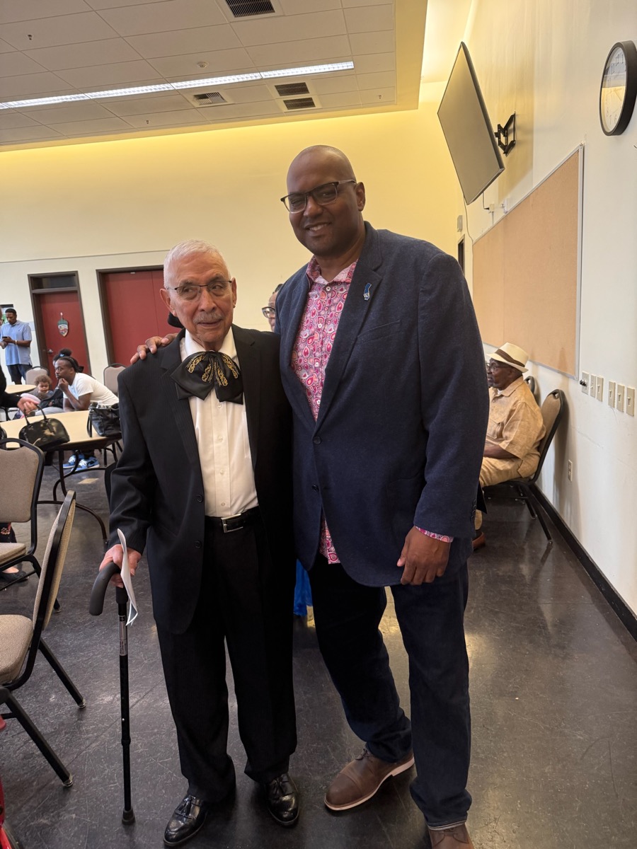 Cedric with community mentor at meeting